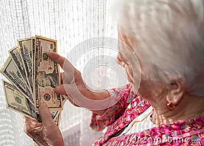 Old woman holding money in hands