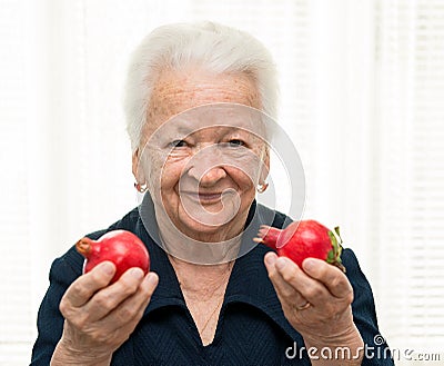 Old woman with pomegranates in her hands