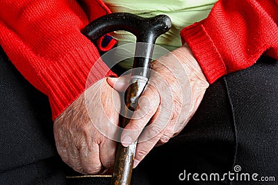 Old womans hands with cane