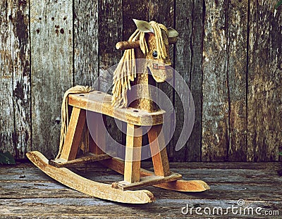 Old wood rocking horse on wood.