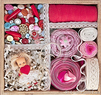 Old wooden box with thread, buttons and ribbons
