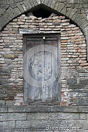 Old wooden door in brick stone wall