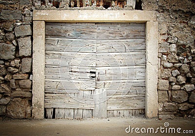 Old wooden door in stone house