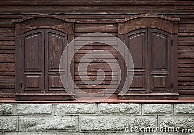 Old wooden window with carved wooden ornaments. Closed windows.