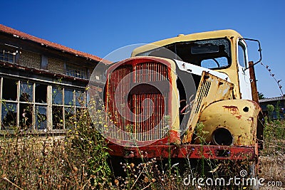 Old, yellow rusty truck on the abandoned farm