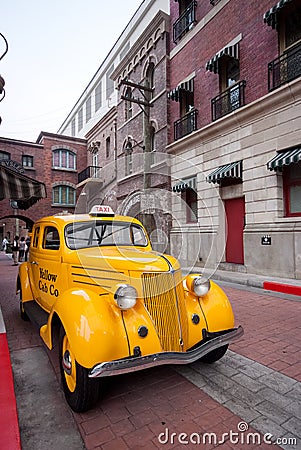 Old yellow taxi in the street view