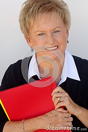 Older business woman with file folders