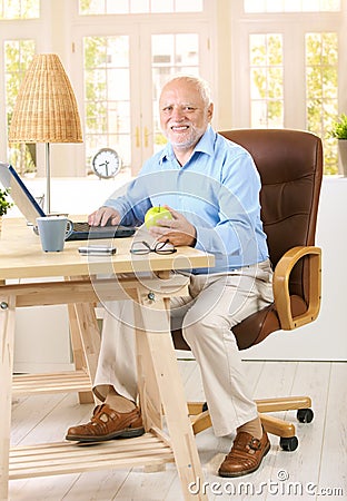 Older man working in his study