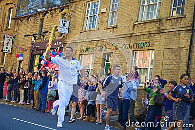 Olympic torch relay runner, Headingley, Leeds, UK
