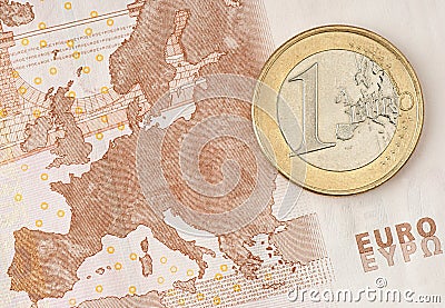 One Euro Coin on Euro Banknote