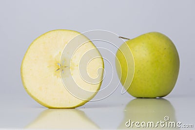 One slice of apple and one whole apple
