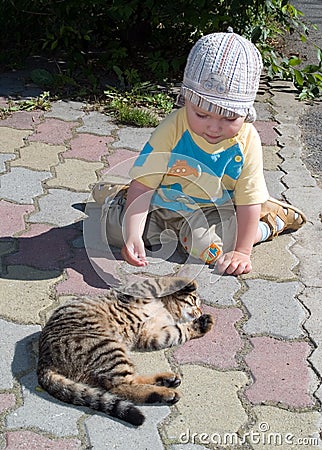 One year boy playing with cat