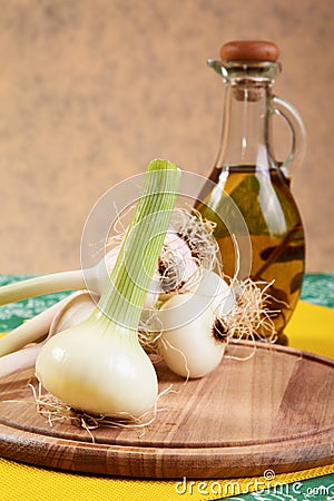 Onion and garlic with an olive oil bottle