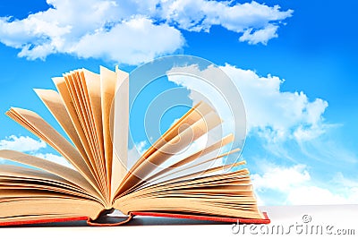 Open book against a blue sky