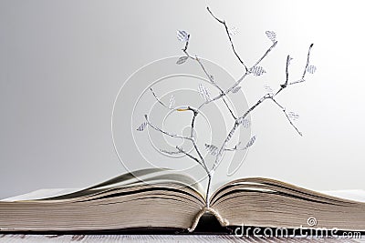 Open book and paper letters tree concept