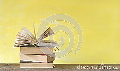 Open book on yellow background, free copy space