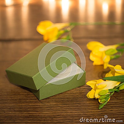 Open gift box with flowers and evening lighting