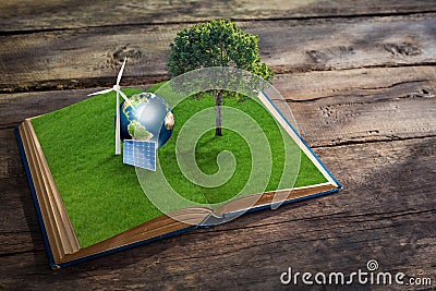 Open grass book with tree on wood background