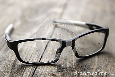 Optical glasses on wooden background