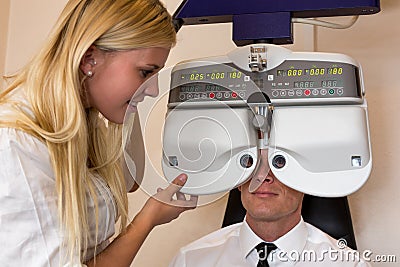 Optician or optometrist and patient with a phoropter