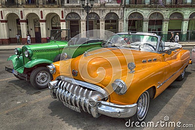 Orange and green cars in front of Capitolio, Havana, Cuba