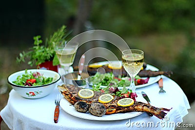 Outdoor dinner with grilled fish salad and coal roasted potatoes