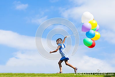 Outdoor portrait of a cute young little black girl playing with