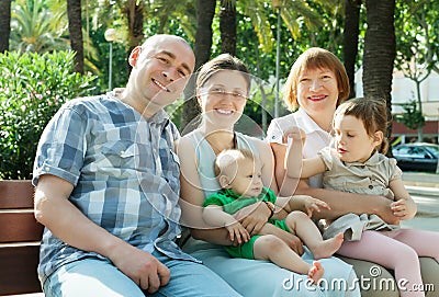 Outdoor portrait of happy multigeneration family of five