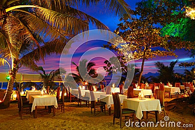 Outdoor restaurant at the beach during sunset