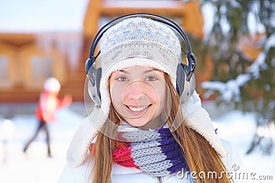 Outdoors on a winter day. Girl listen music.