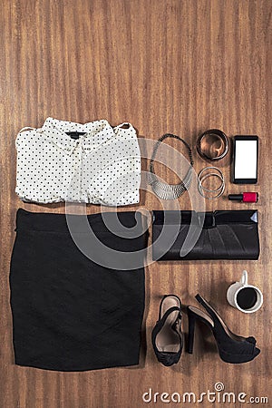 Outfit of business woman on wood background.