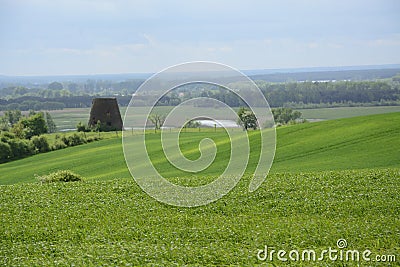 Outside the city - rural landscape - an old windmill on the fiel