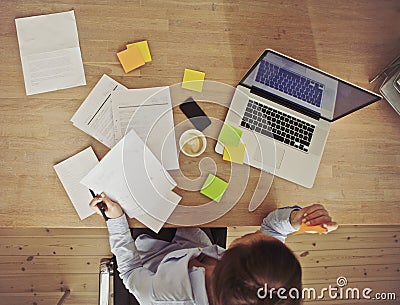 Overhead view of businesswoman working at desk
