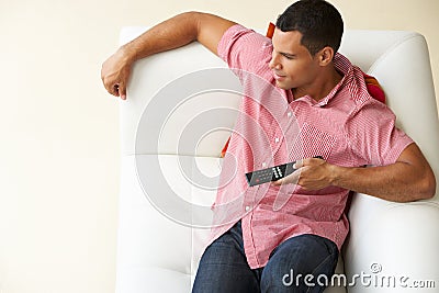 Overhead View Of Man Relaxing On Sofa Watching Television