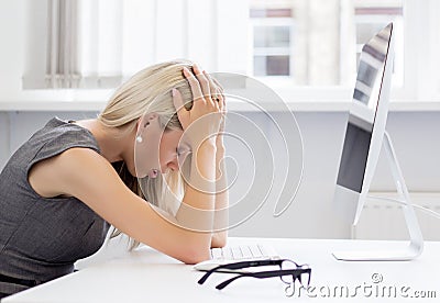 Overworked and frustrated young woman in front of computer