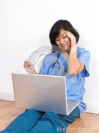 Overworked woman doctor or nurse at computer