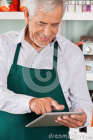 Owner Using Digital Tablet In Grocery Store