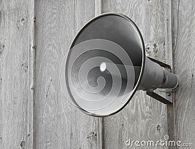 PA Speaker on wooden wall.