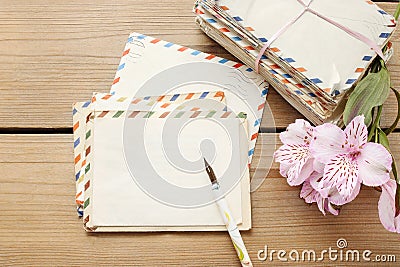 Package of vintage letters, pen and pink alstroemeria flowers