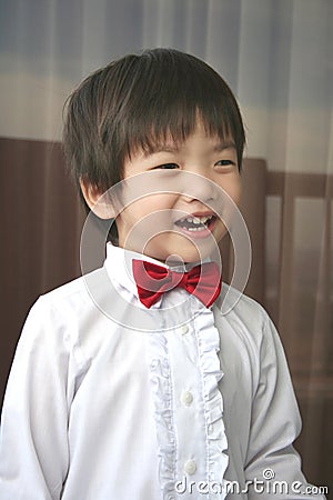 Page boy with red bow-tie smiling