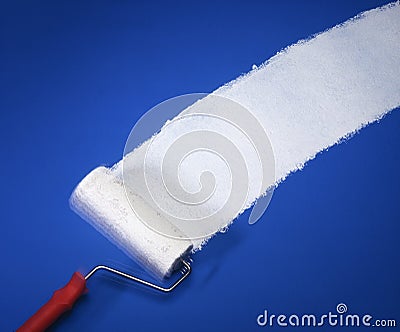 Paint roller with white paint on blue wall