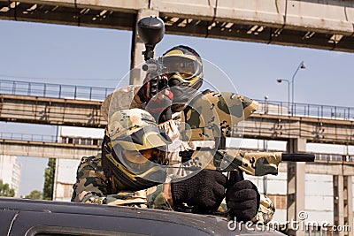 Paintball players on the car