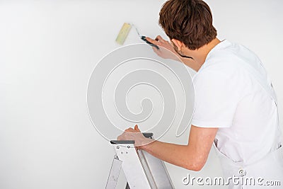 Painter standing on a stepladder