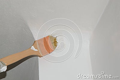 Painting a wall corner with a brush