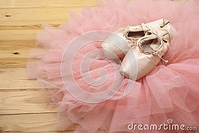 Pair of ballet shoes pointes on wooden floor
