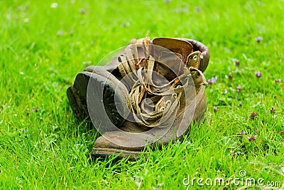 Pair of old boots on grass