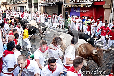 PAMPLONA, SPAIN -JULY 8: Unidentified men run from bulls in stre