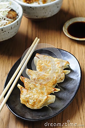 Pan-fried gyoza with dipping sauce