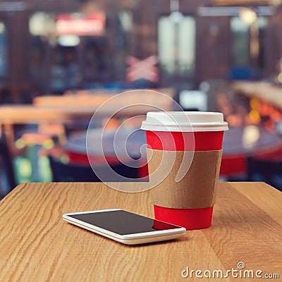 Paper coffee cup and smart phone