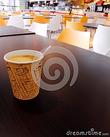 Paper cup of coffee on cafeteria table top